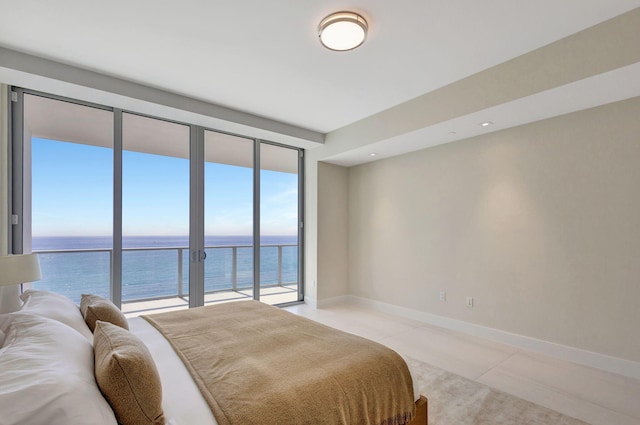 bedroom featuring light tile patterned floors, access to outside, and a water view