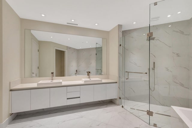 bathroom with vanity and a shower with shower door