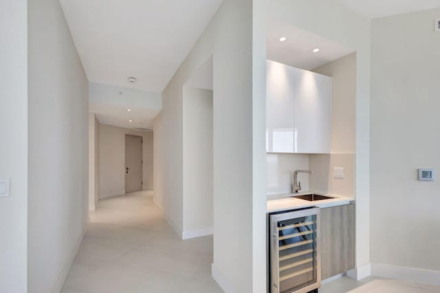 hallway with sink and wine cooler