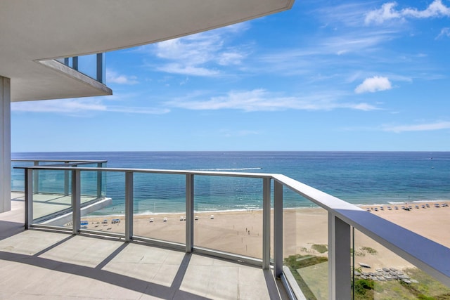 balcony with a view of the beach and a water view