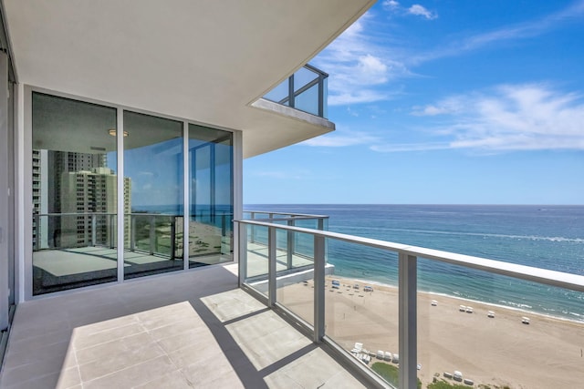 balcony with a water view and a beach view