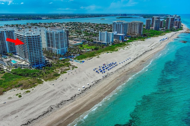 aerial view with a water view and a view of the beach