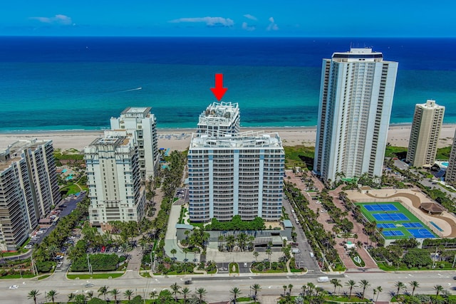 drone / aerial view with a beach view and a water view