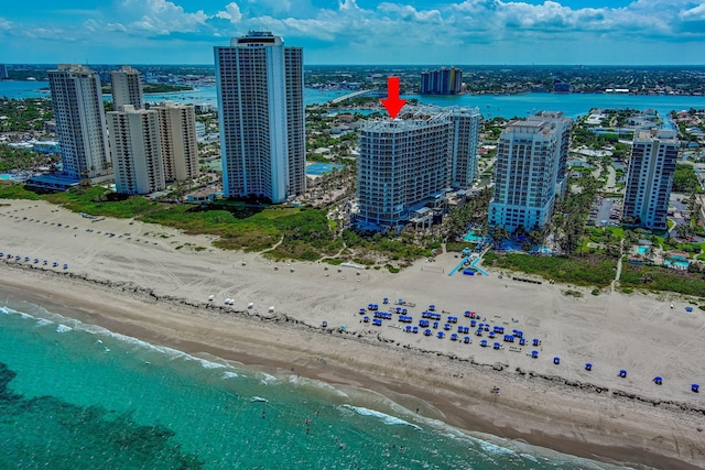 drone / aerial view featuring a view of the beach and a water view