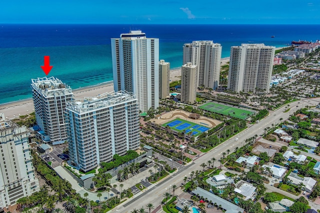 aerial view with a water view and a view of the beach