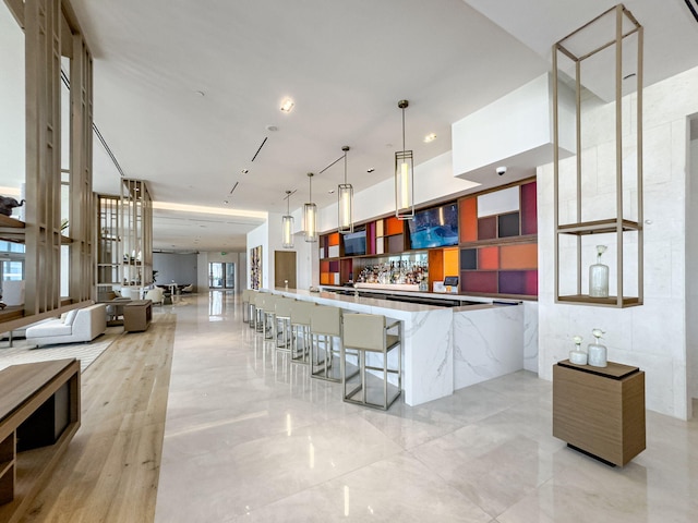 kitchen with a kitchen breakfast bar, kitchen peninsula, and hanging light fixtures