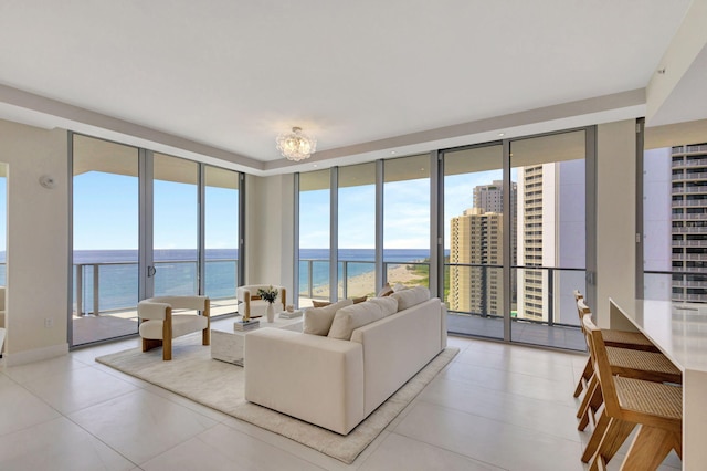 living room with a water view, floor to ceiling windows, and a notable chandelier