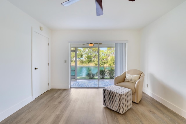 sitting room featuring light hardwood / wood-style flooring and ceiling fan