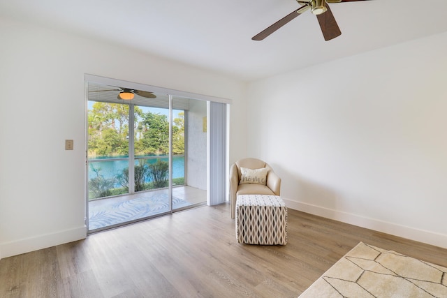 sitting room with light hardwood / wood-style floors and ceiling fan