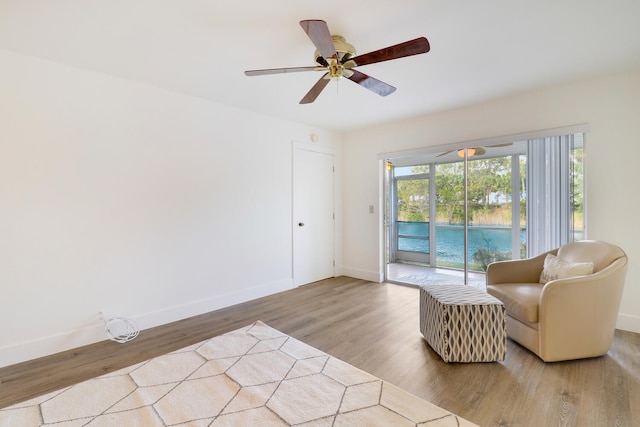 sitting room featuring light hardwood / wood-style floors and ceiling fan