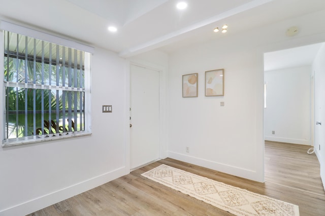 interior space with beamed ceiling and light wood-type flooring