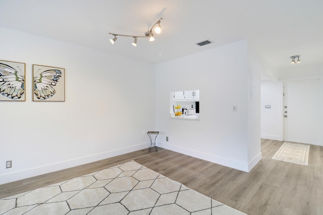 laundry room featuring sink and light hardwood / wood-style floors