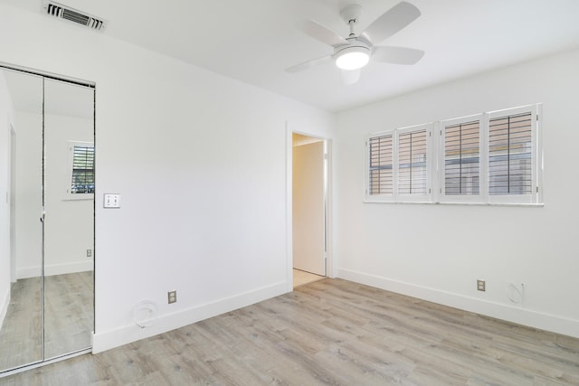 empty room featuring ceiling fan and light wood-type flooring