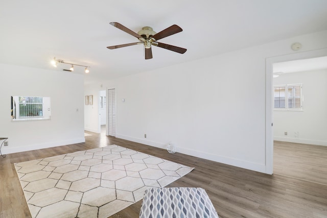 empty room featuring dark hardwood / wood-style flooring and ceiling fan