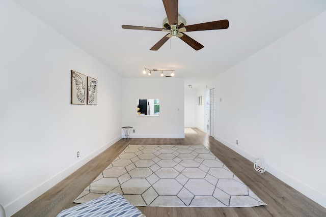 spare room with wood-type flooring and ceiling fan