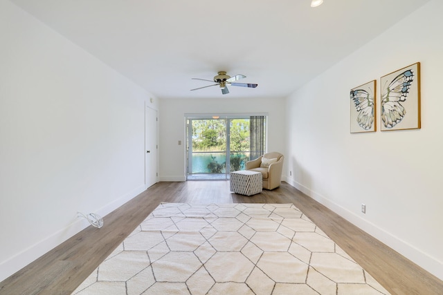 living area featuring ceiling fan and light wood-type flooring