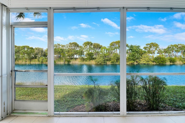 unfurnished sunroom with a water view