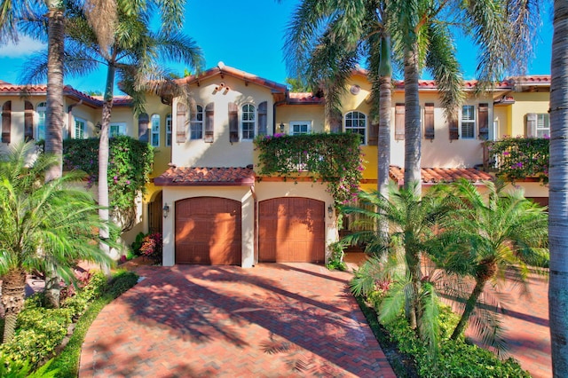 mediterranean / spanish-style home with a garage