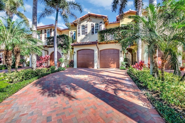 mediterranean / spanish-style home with a garage