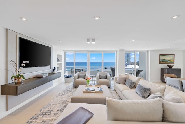 living room featuring floor to ceiling windows and light tile patterned floors