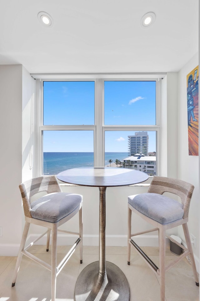 dining room with a healthy amount of sunlight and a water view