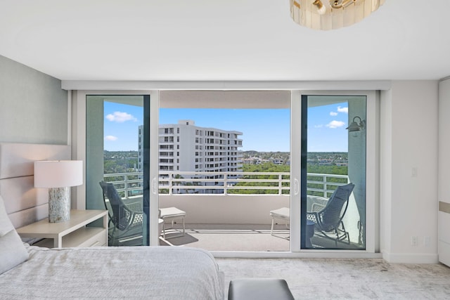 bedroom featuring access to exterior and carpet floors