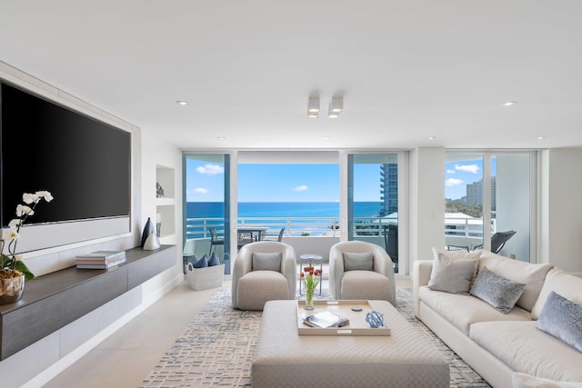 living room with light tile patterned flooring, expansive windows, and a water view