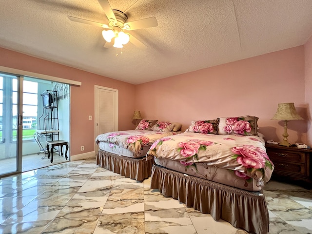 bedroom featuring ceiling fan, access to exterior, a textured ceiling, and a closet