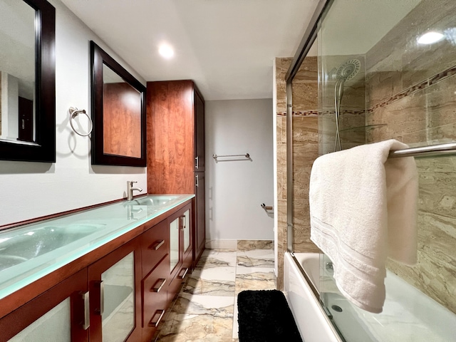 bathroom with vanity and shower / bath combination with glass door