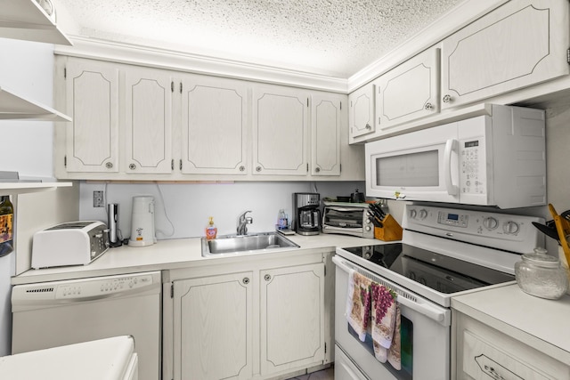 kitchen featuring white appliances, sink, and white cabinets