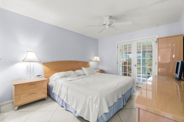 tiled bedroom featuring ceiling fan, access to outside, a textured ceiling, and french doors