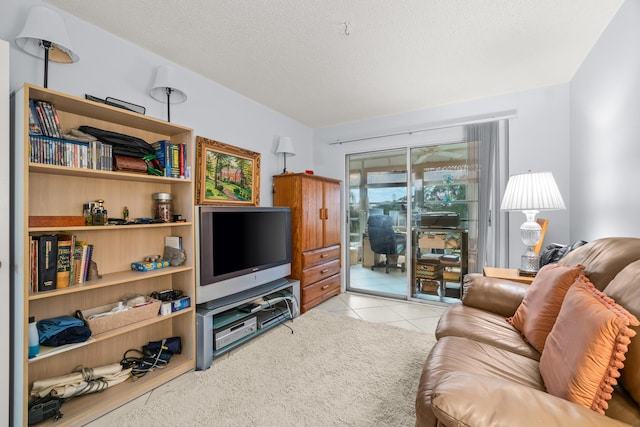 tiled living room featuring a textured ceiling