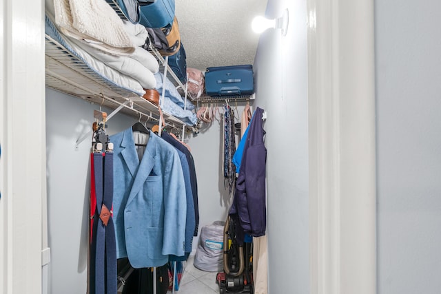 walk in closet with light tile patterned floors