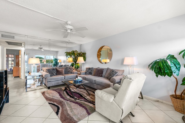 tiled living room featuring ceiling fan and a textured ceiling