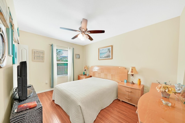 bedroom with ceiling fan and light wood-type flooring