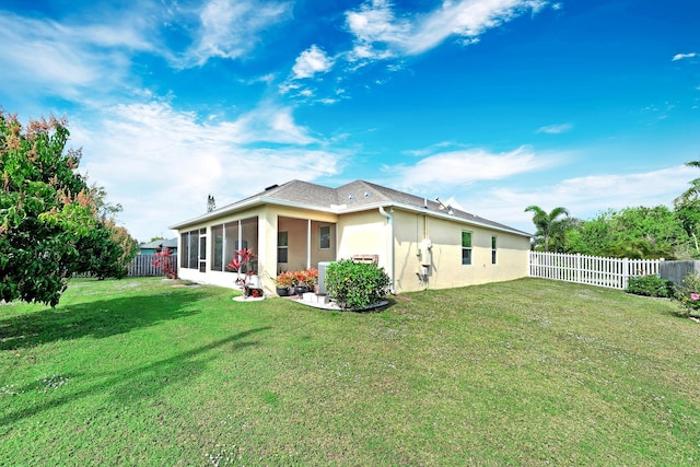 back of house featuring a lawn