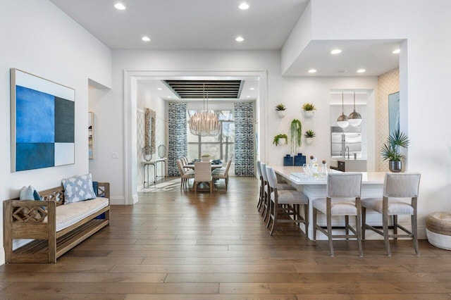 dining area with an inviting chandelier and dark hardwood / wood-style floors