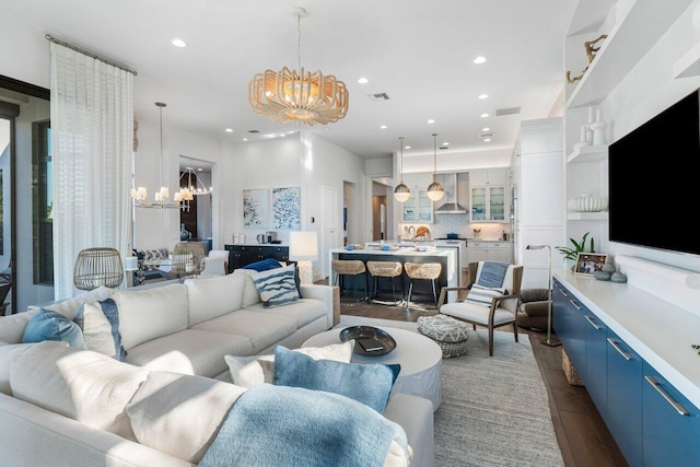 living room with dark hardwood / wood-style flooring and an inviting chandelier