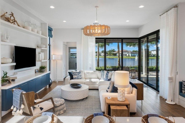 living room featuring an inviting chandelier, a wealth of natural light, and dark hardwood / wood-style floors