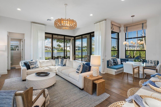 living room featuring dark wood-type flooring and a notable chandelier