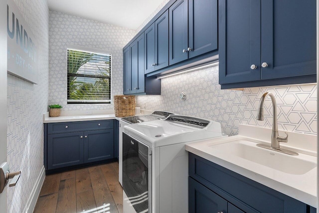 washroom with cabinets, sink, washing machine and clothes dryer, and dark hardwood / wood-style floors