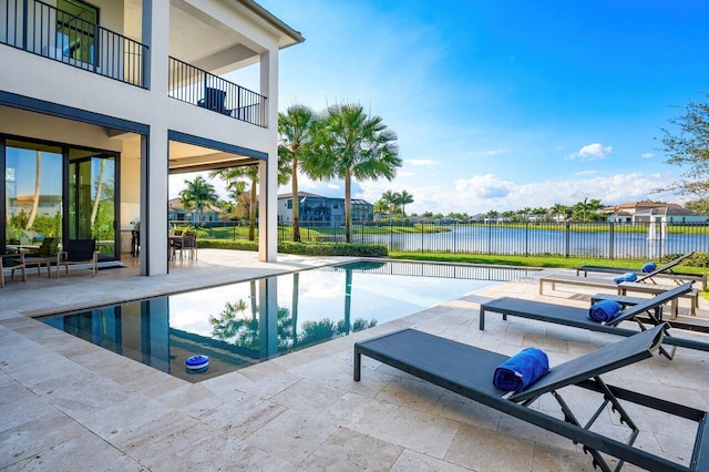 view of swimming pool featuring a water view and a patio area