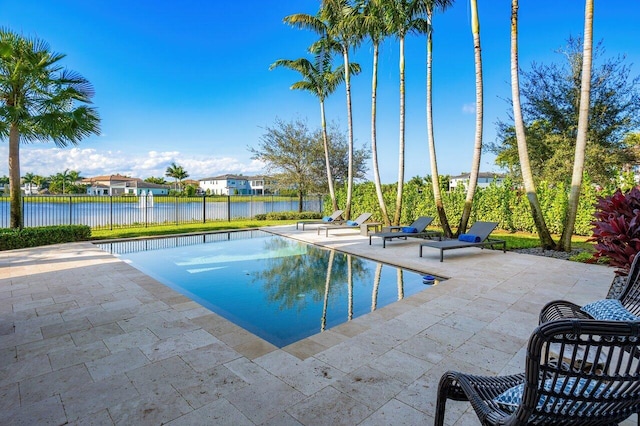 view of pool featuring a water view and a patio area