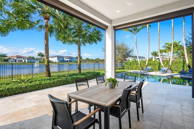 view of patio featuring a water view and a fenced in pool