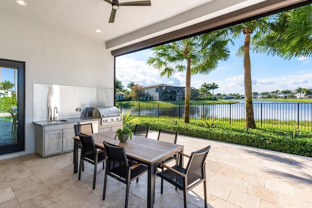 view of patio featuring sink, ceiling fan, a water view, a grill, and area for grilling