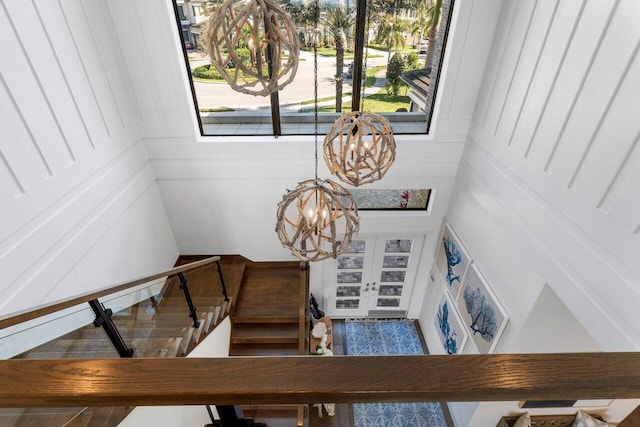 staircase with a chandelier