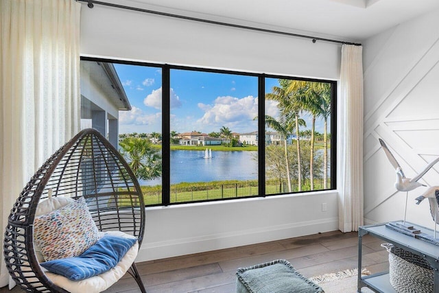 interior space with a water view and hardwood / wood-style floors