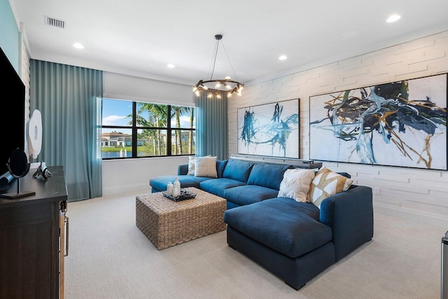 carpeted living room featuring a chandelier