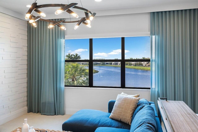 sitting room featuring a water view and carpet floors