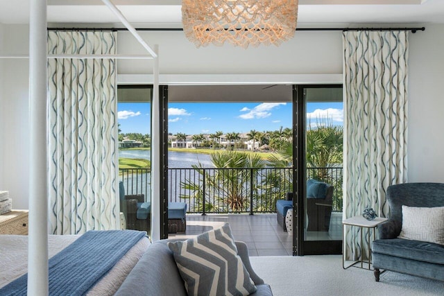 bedroom with a water view, tile patterned floors, and access to outside